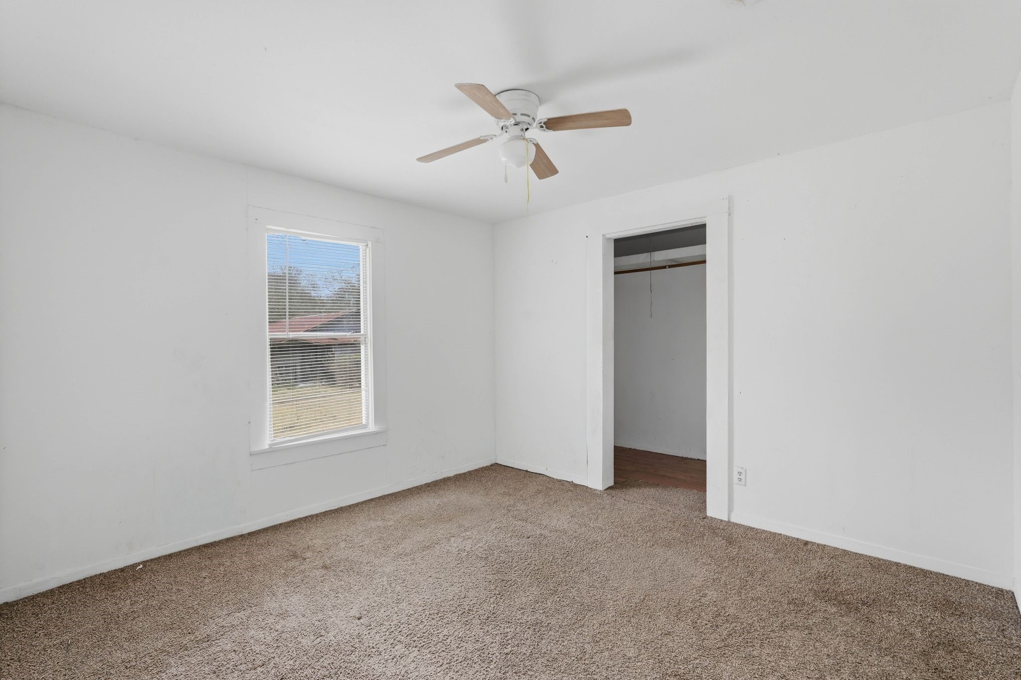 3110 Green Forest Road Conroe, TX 77303 - Photo 45 of 50 an empty room with a ceiling fan and windows