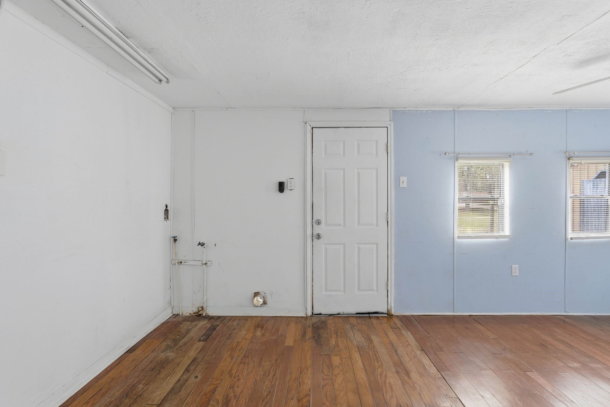 3110 Green Forest Road Conroe, TX 77303 - Photo 46 of 50 a view of an empty room with wooden floor and a window