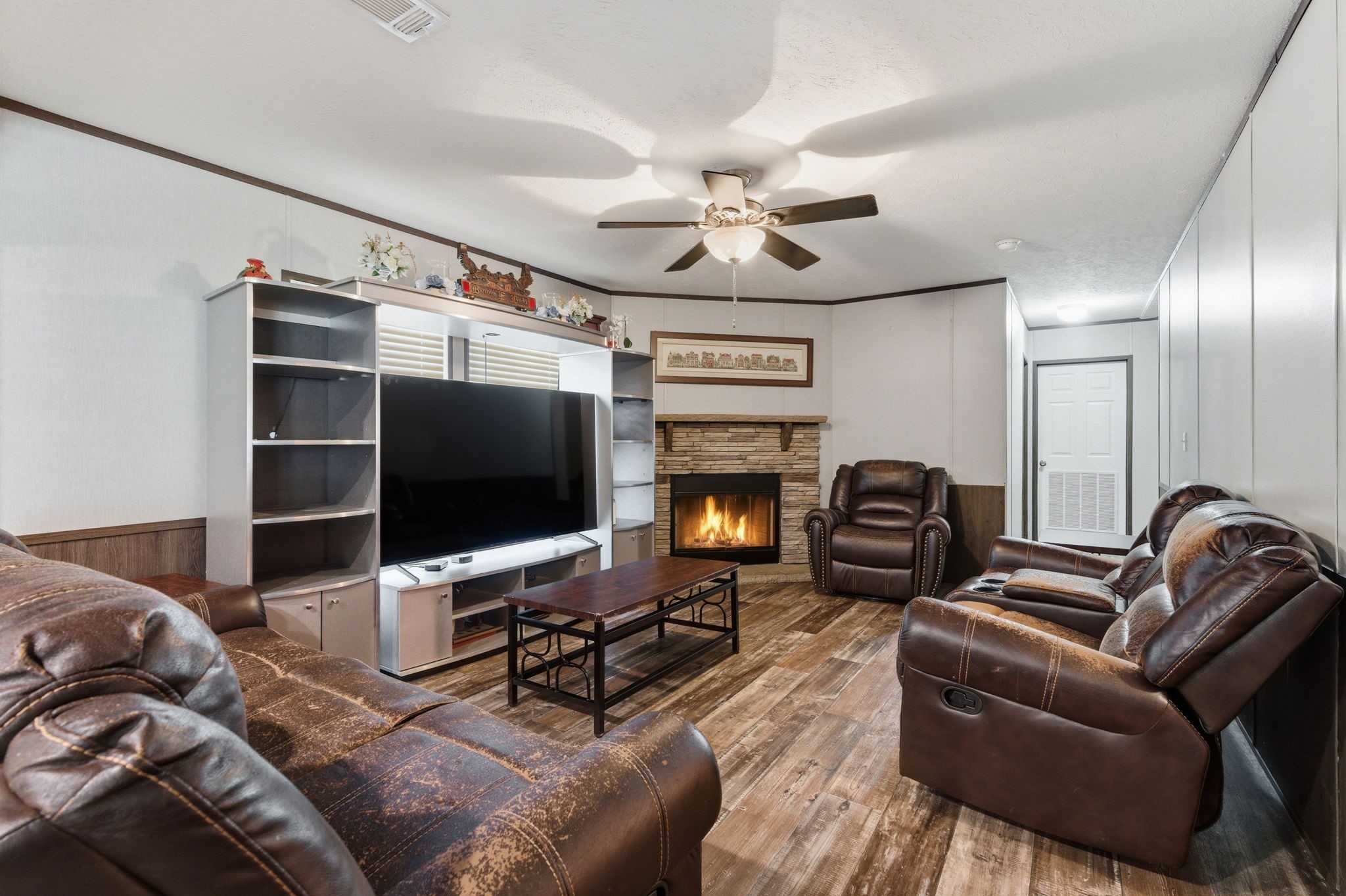 3110 Green Forest Road Conroe, TX 77303 - Photo 10 of 50 a living room with furniture a flat screen tv and a fireplace