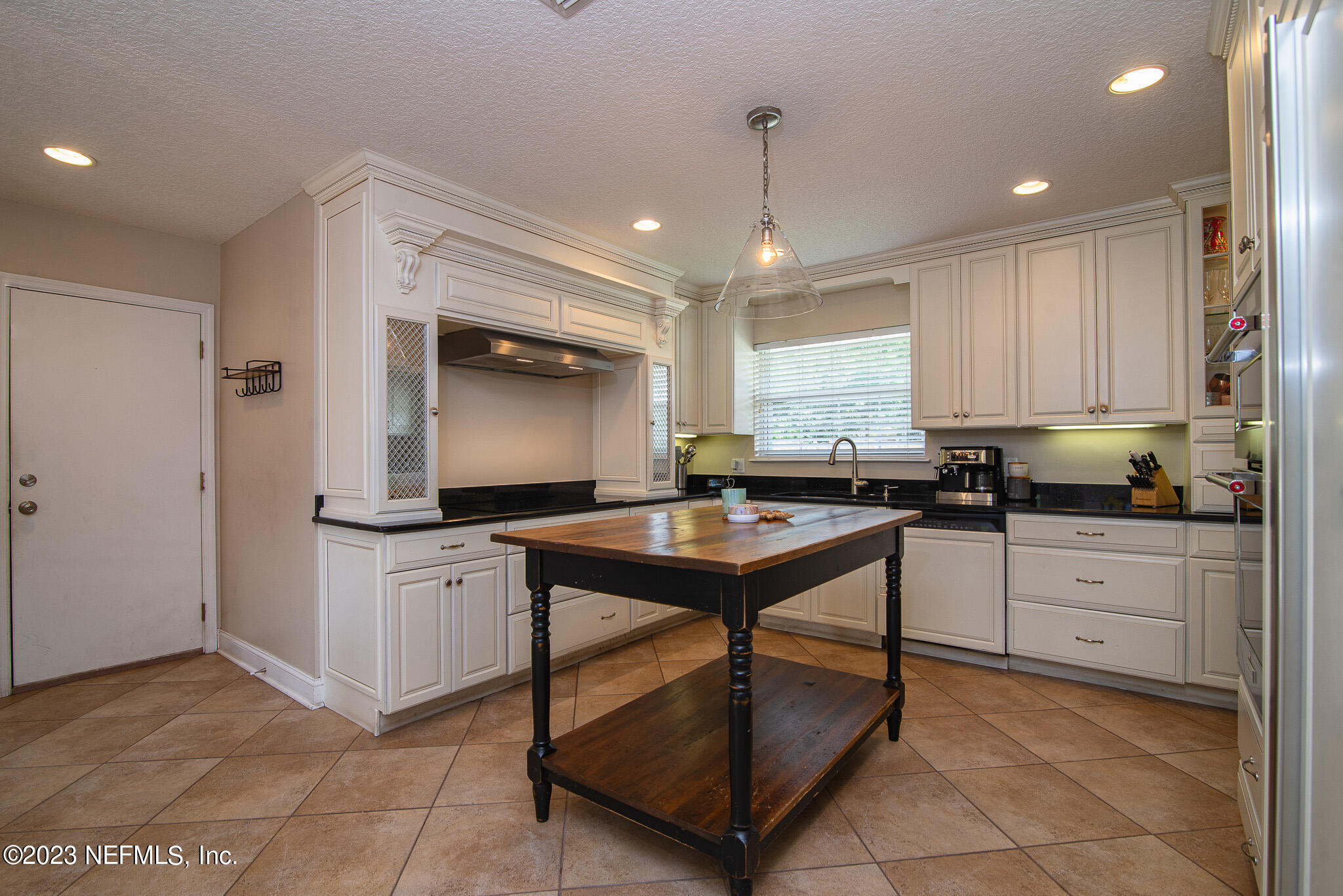 9409 Woodhaven Road Jacksonville, FL 32257 - Photo 11 of 38 a kitchen with sink cabinets and window
