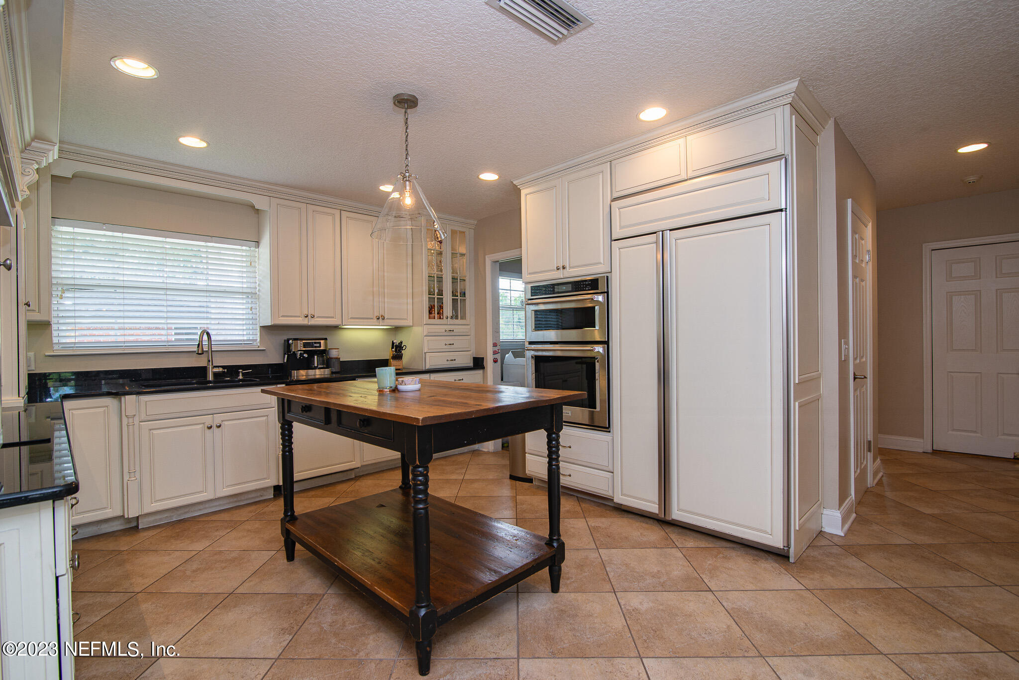 9409 Woodhaven Road Jacksonville, FL 32257 - Photo 12 of 38 a kitchen with stainless steel appliances granite countertop a refrigerator and a sink