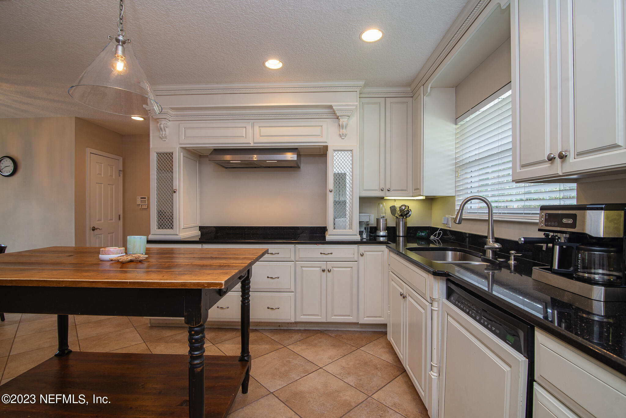 9409 Woodhaven Road Jacksonville, FL 32257 - Photo 13 of 38 a kitchen with granite countertop a sink and white cabinets
