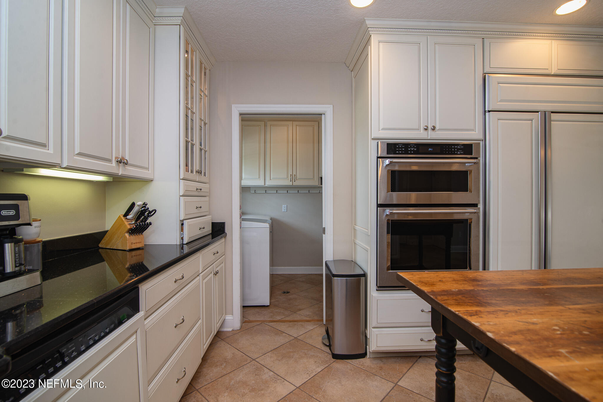 9409 Woodhaven Road Jacksonville, FL 32257 - Photo 14 of 38 a kitchen with granite countertop a sink stove and refrigerator