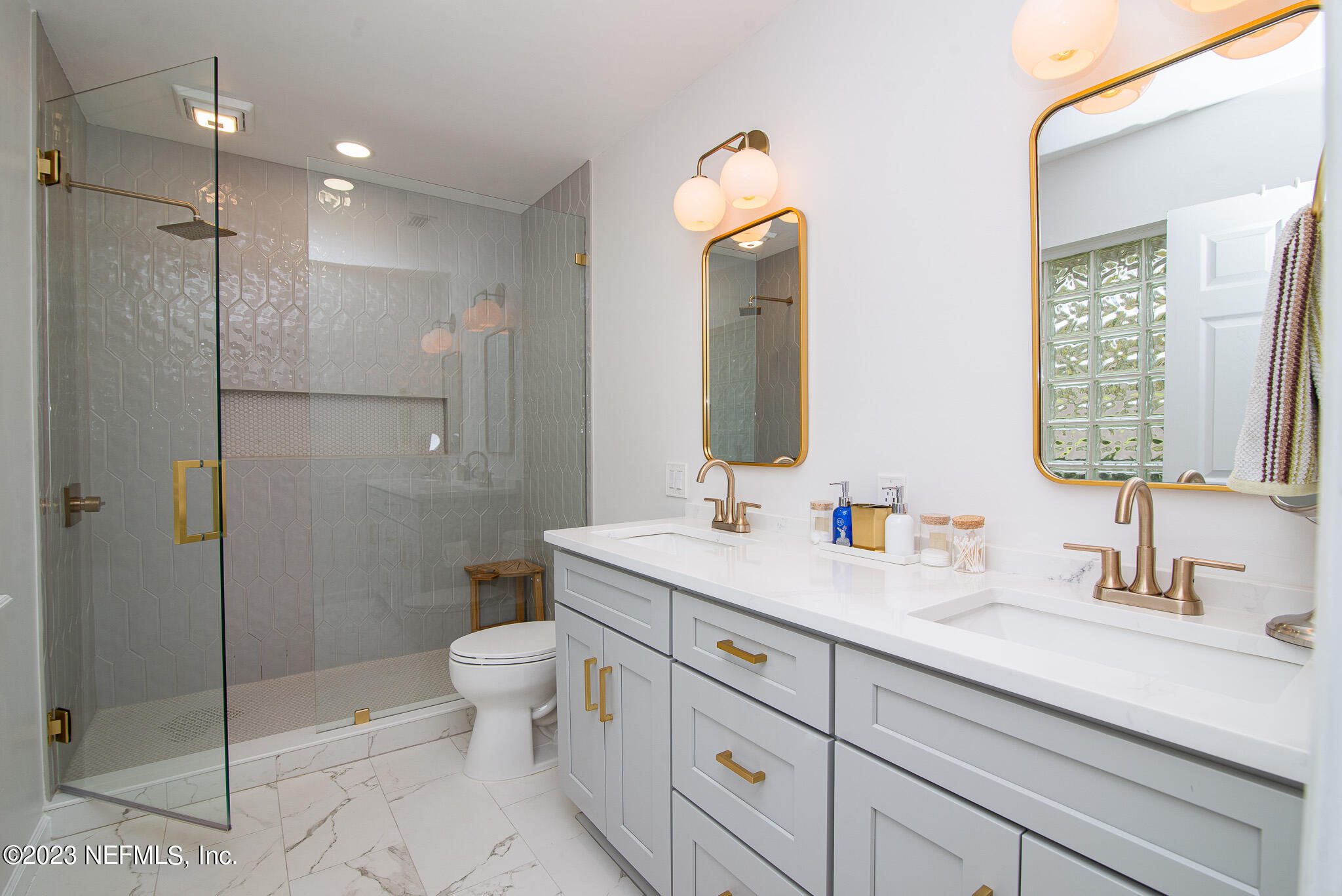 9409 Woodhaven Road Jacksonville, FL 32257 - Photo 20 of 38 a bathroom with a double vanity sink toilet and shower