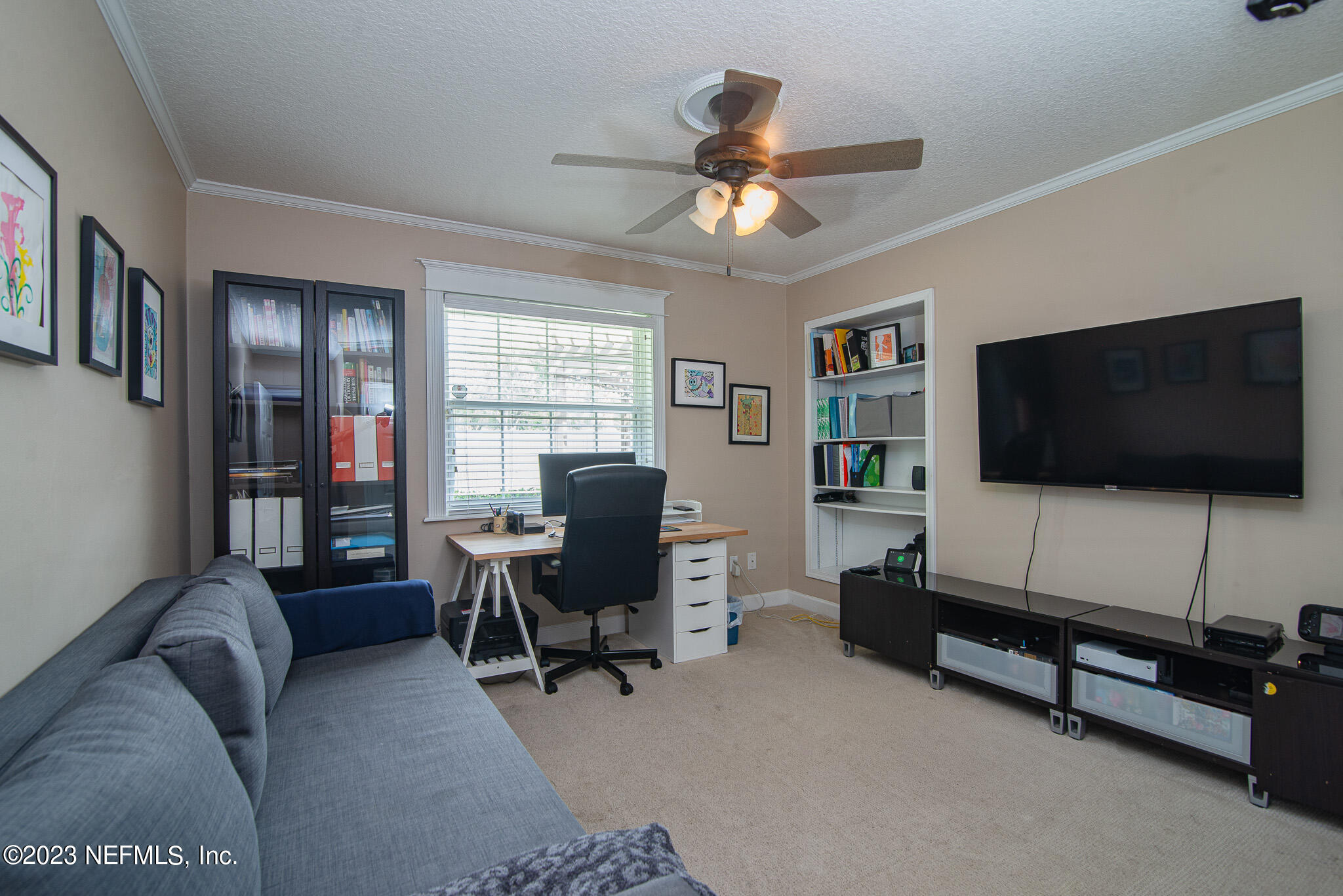 9409 Woodhaven Road Jacksonville, FL 32257 - Photo 25 of 38 a living room with furniture and a flat screen tv
