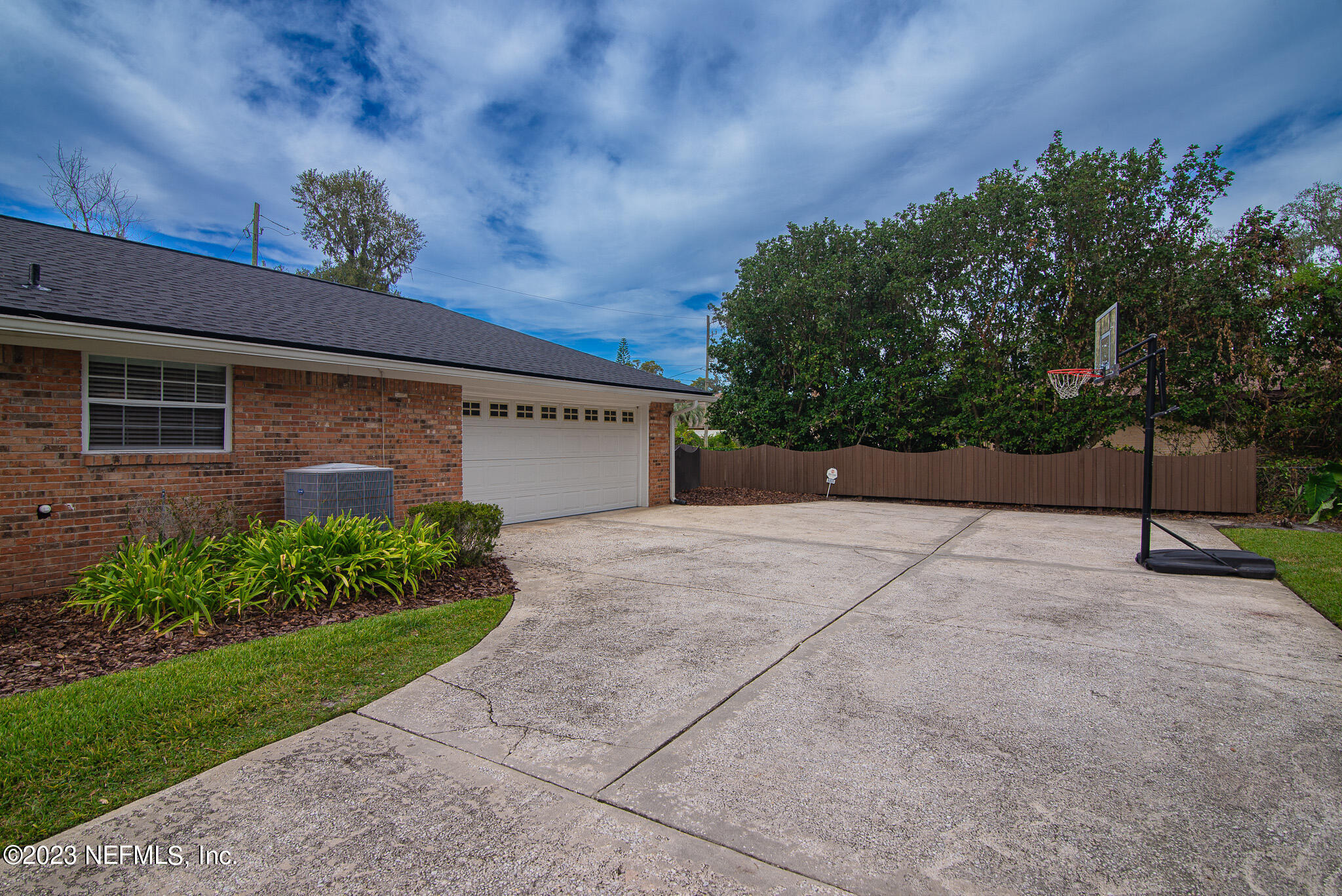 9409 Woodhaven Road Jacksonville, FL 32257 - Photo 3 of 38 a view of a house with a yard and garage