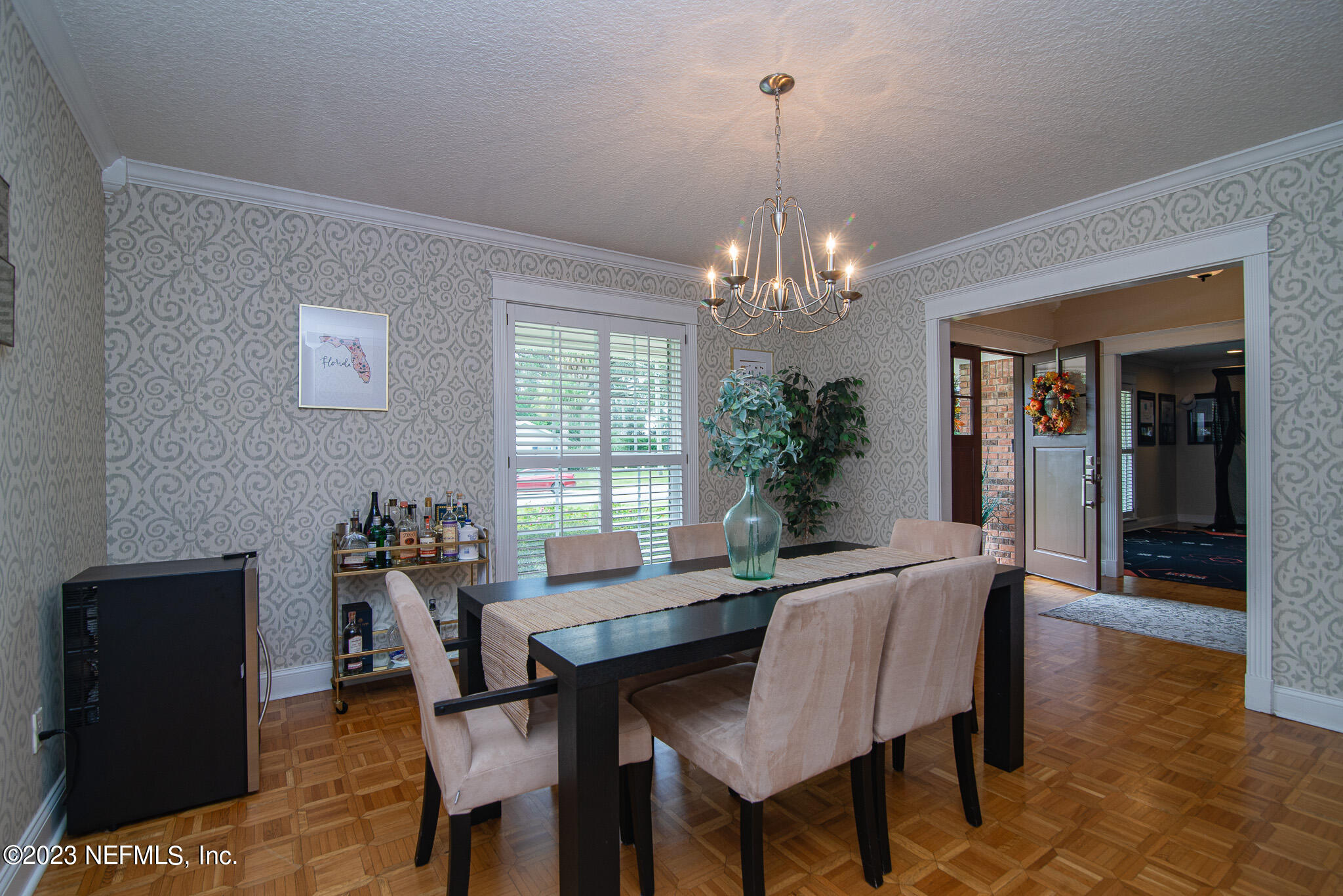 9409 Woodhaven Road Jacksonville, FL 32257 - Photo 6 of 38 a view of a dining room with furniture and chandelier