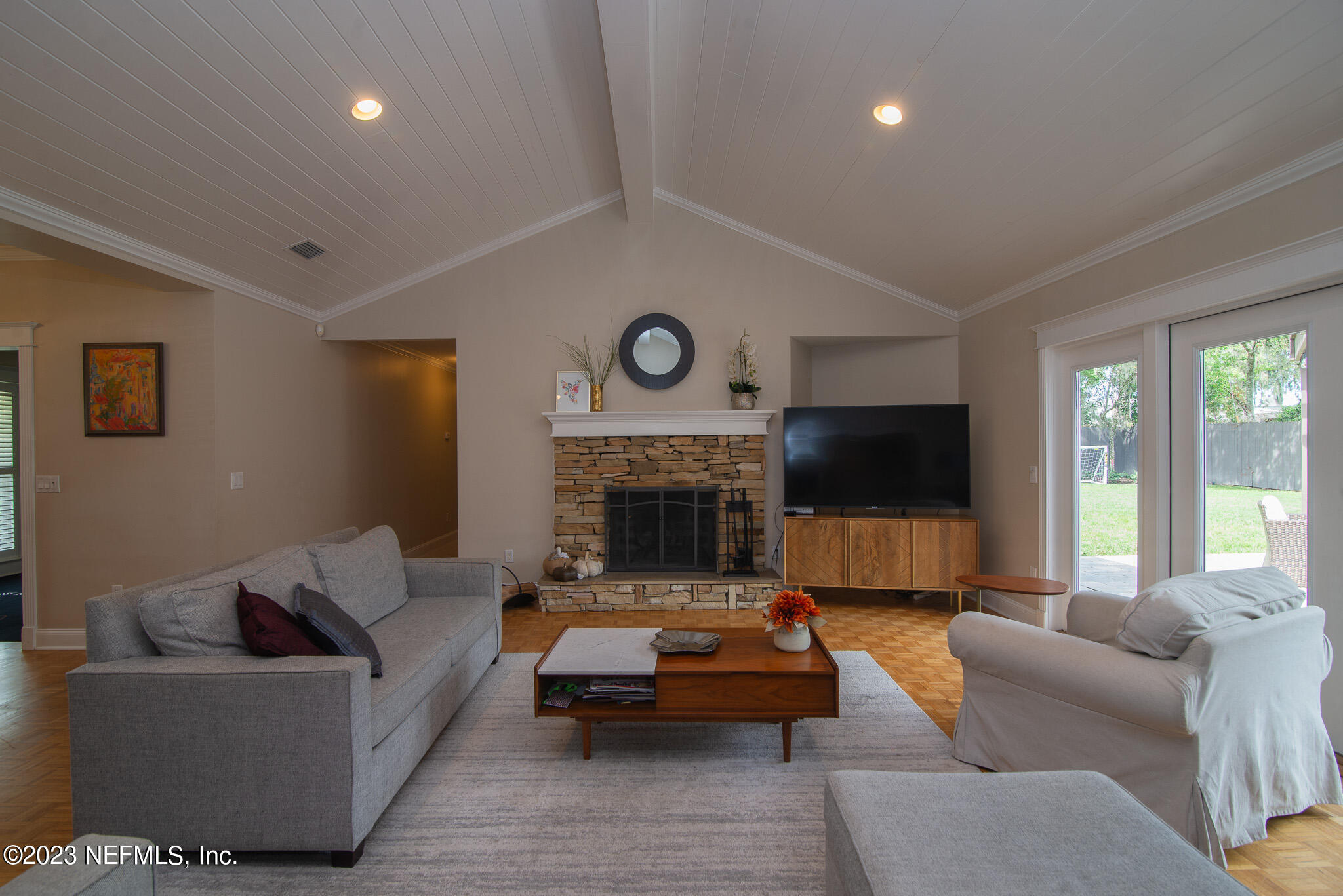 9409 Woodhaven Road Jacksonville, FL 32257 - Photo 8 of 38 a living room with furniture flat screen tv and a fireplace