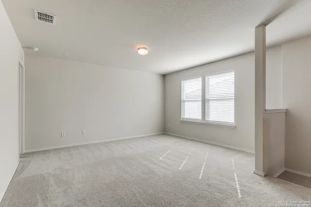 an empty room with a empty space and windows