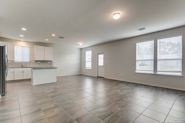 a view of kitchen with granite countertop cabinets and a sink
