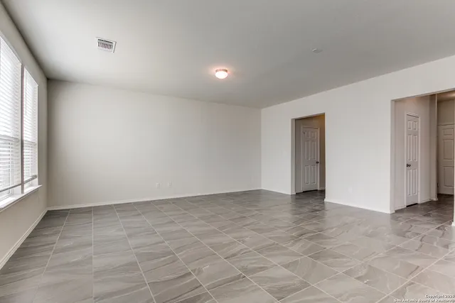 a view of an empty room with a window