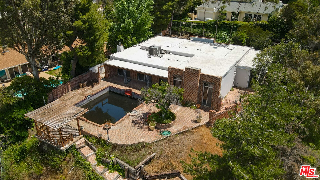 a view of a house with pool and garden