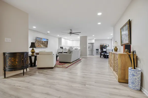 a living room with furniture and a wooden floor