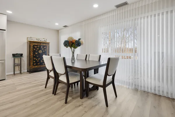 a dining room with furniture and window