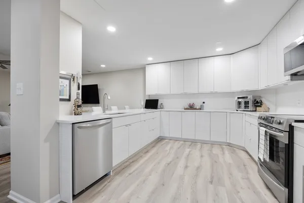 a kitchen with a sink stainless steel appliances and cabinets