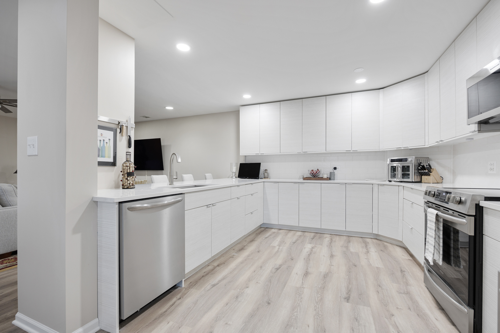 1401 Burr Oak Road, Unit 117B Hinsdale, IL 60521 - Photo 9 of 26 a kitchen with white cabinets and stainless steel appliances
