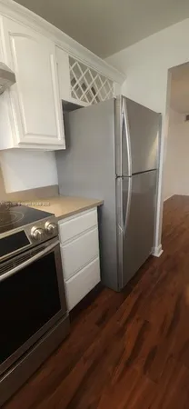 a stove top oven sitting inside of a kitchen