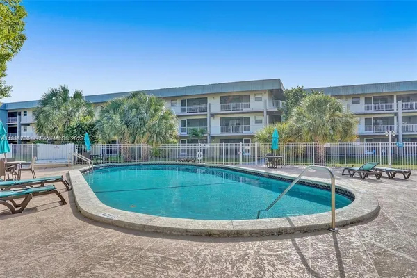 a view of a swimming pool with chairs