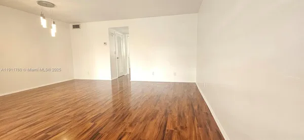 a view of wooden floor in an empty room
