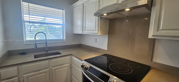 a kitchen with a stove and a sink