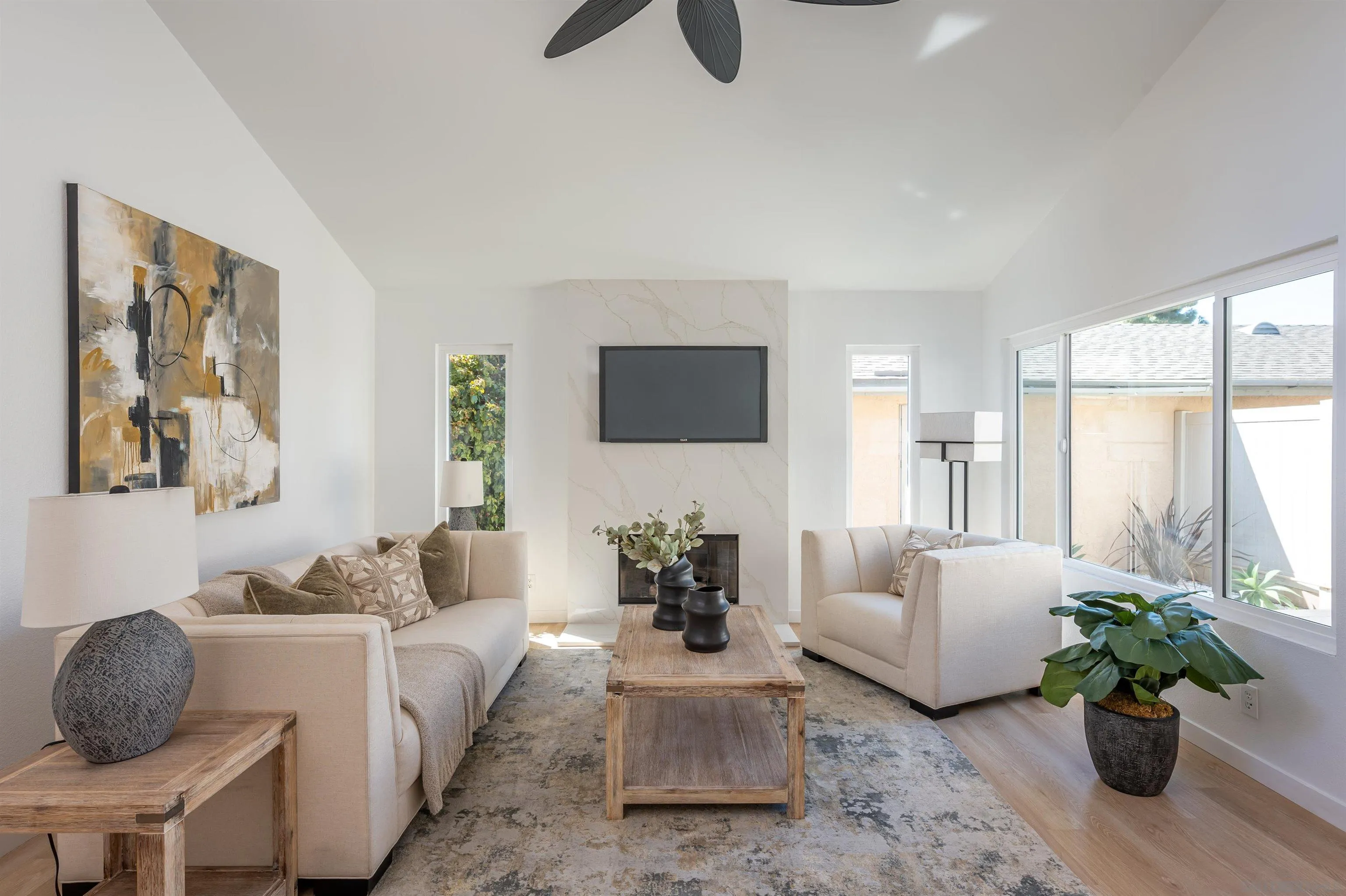 a living room with furniture potted plant and a window