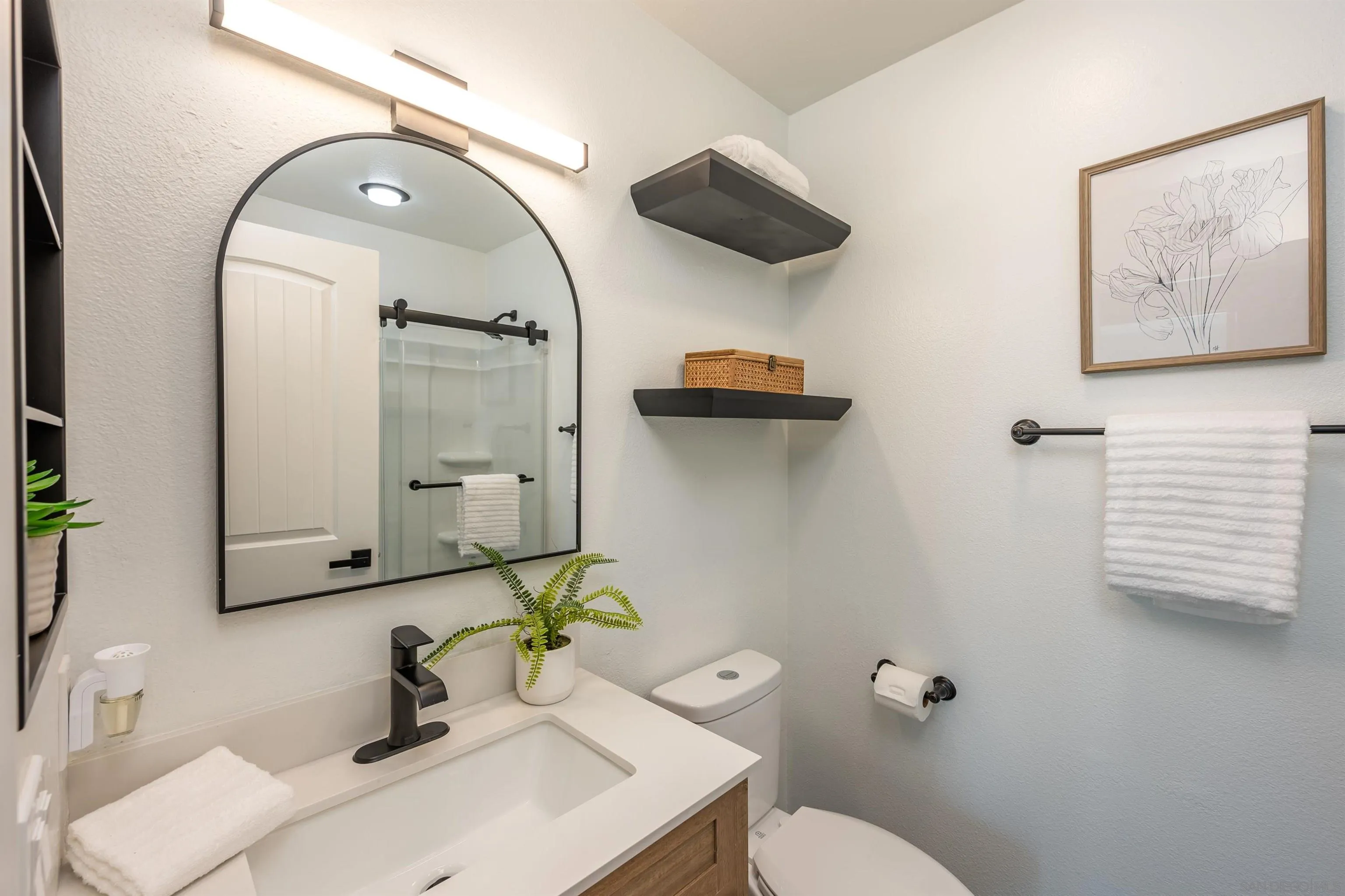 3577 Guava Way Oceanside, CA 92058 - Photo 17 of 42 a bathroom with a sink toilet and mirror