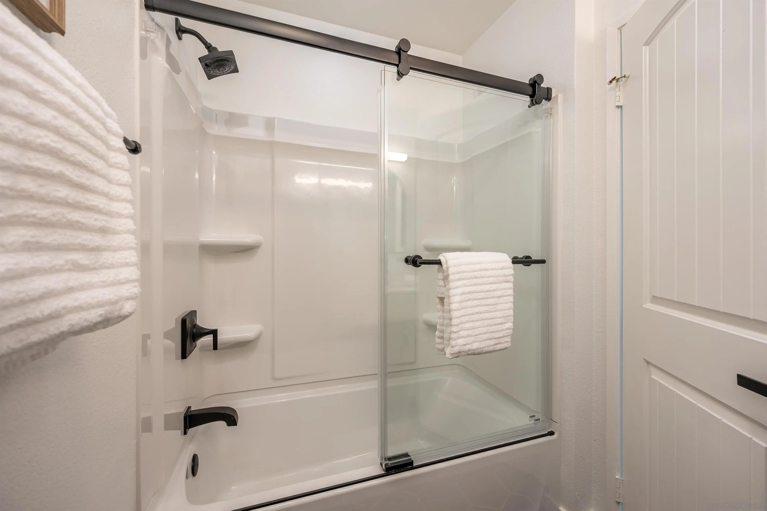 3577 Guava Way Oceanside, CA 92058 - Photo 18 of 42 a bathroom with a glass shower door