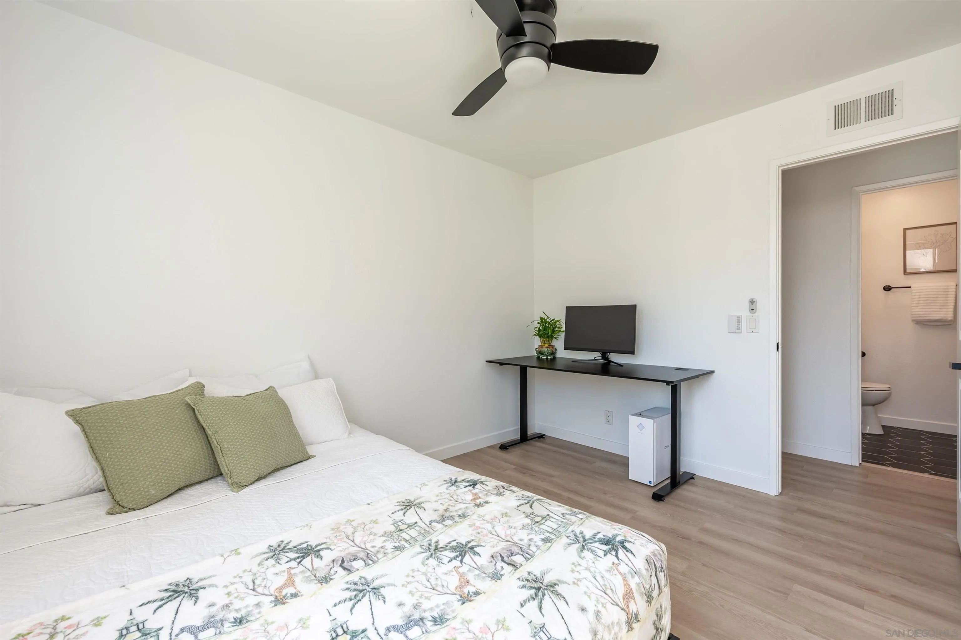 3577 Guava Way Oceanside, CA 92058 - Photo 22 of 42 a bedroom with a bed and wooden floor