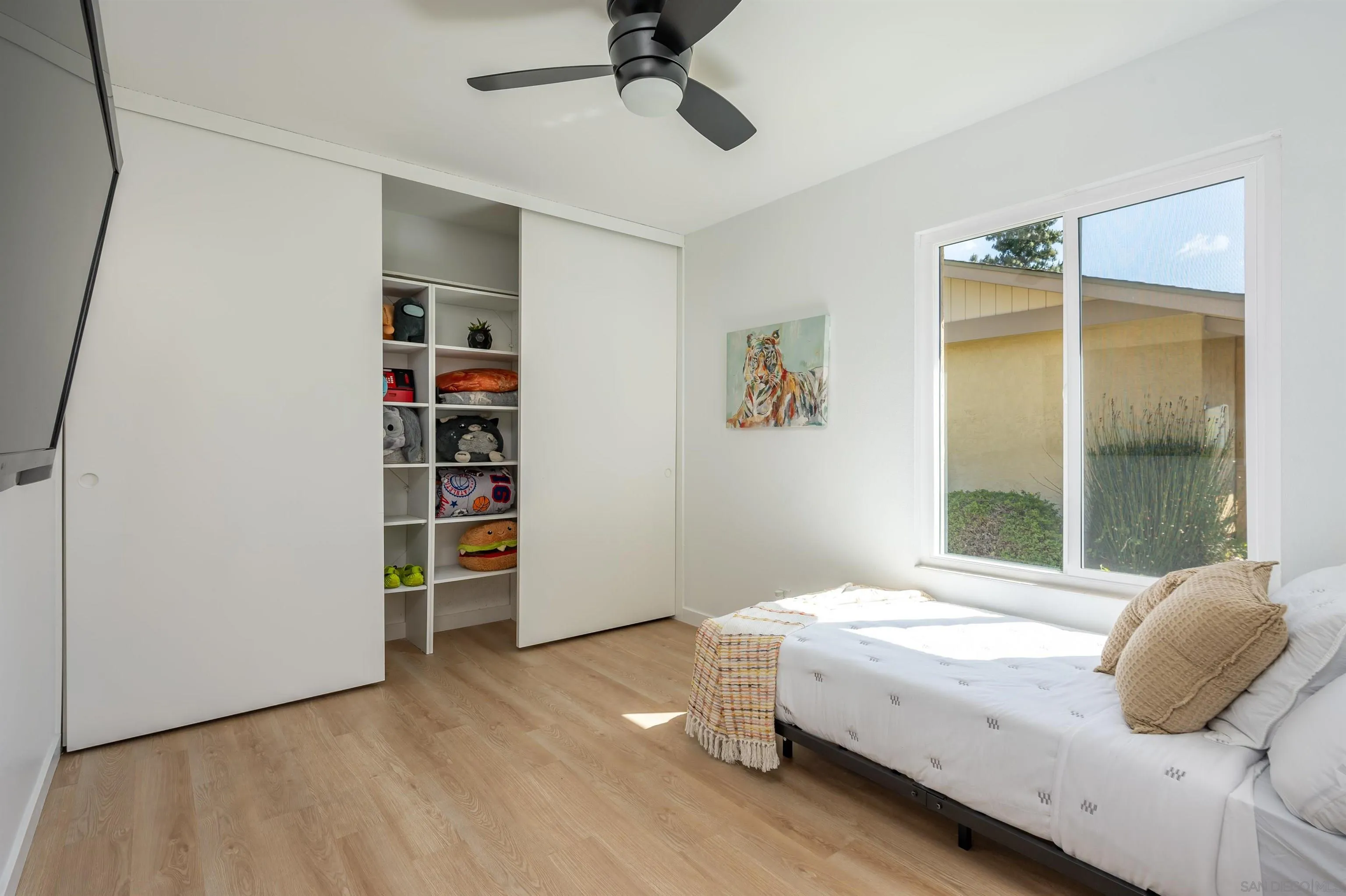 3577 Guava Way Oceanside, CA 92058 - Photo 23 of 42 a bedroom with a bed and a book shelf