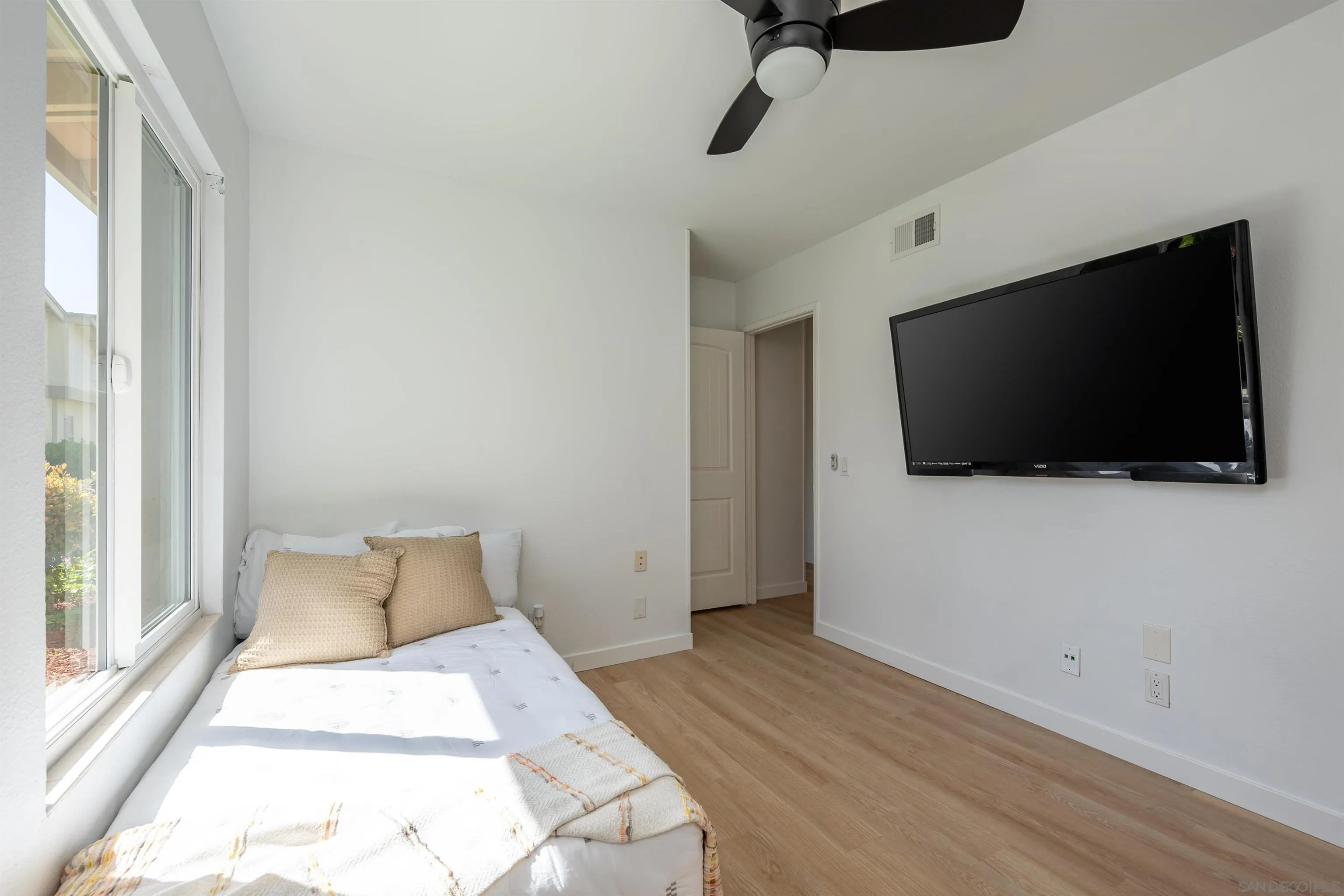 3577 Guava Way Oceanside, CA 92058 - Photo 24 of 42 a bedroom with a bed and a flat screen tv