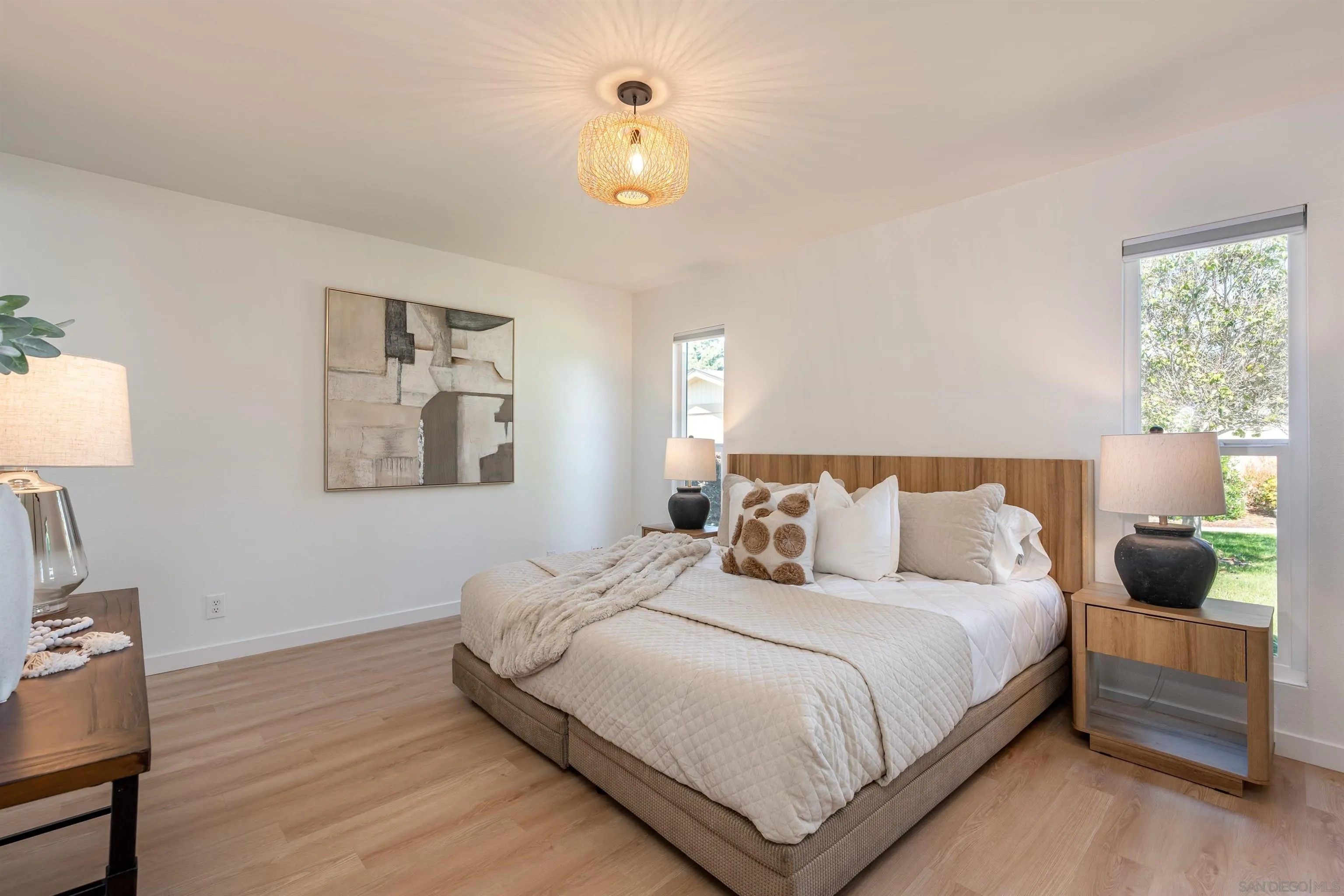 3577 Guava Way Oceanside, CA 92058 - Photo 26 of 42 a bedroom with a bed lamp on table and a window