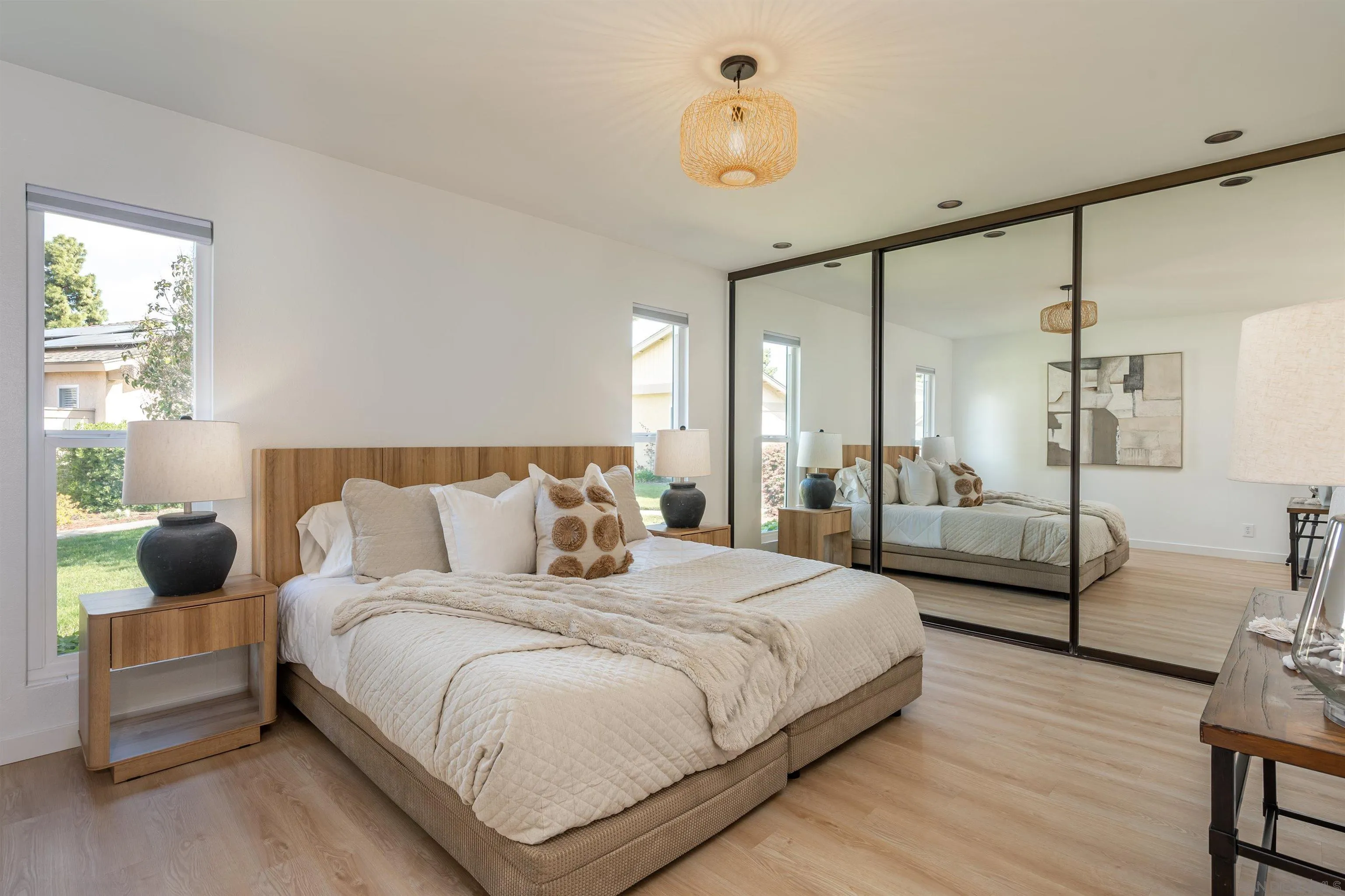 3577 Guava Way Oceanside, CA 92058 - Photo 27 of 42 a bedroom with a bed a chandelier and a couch