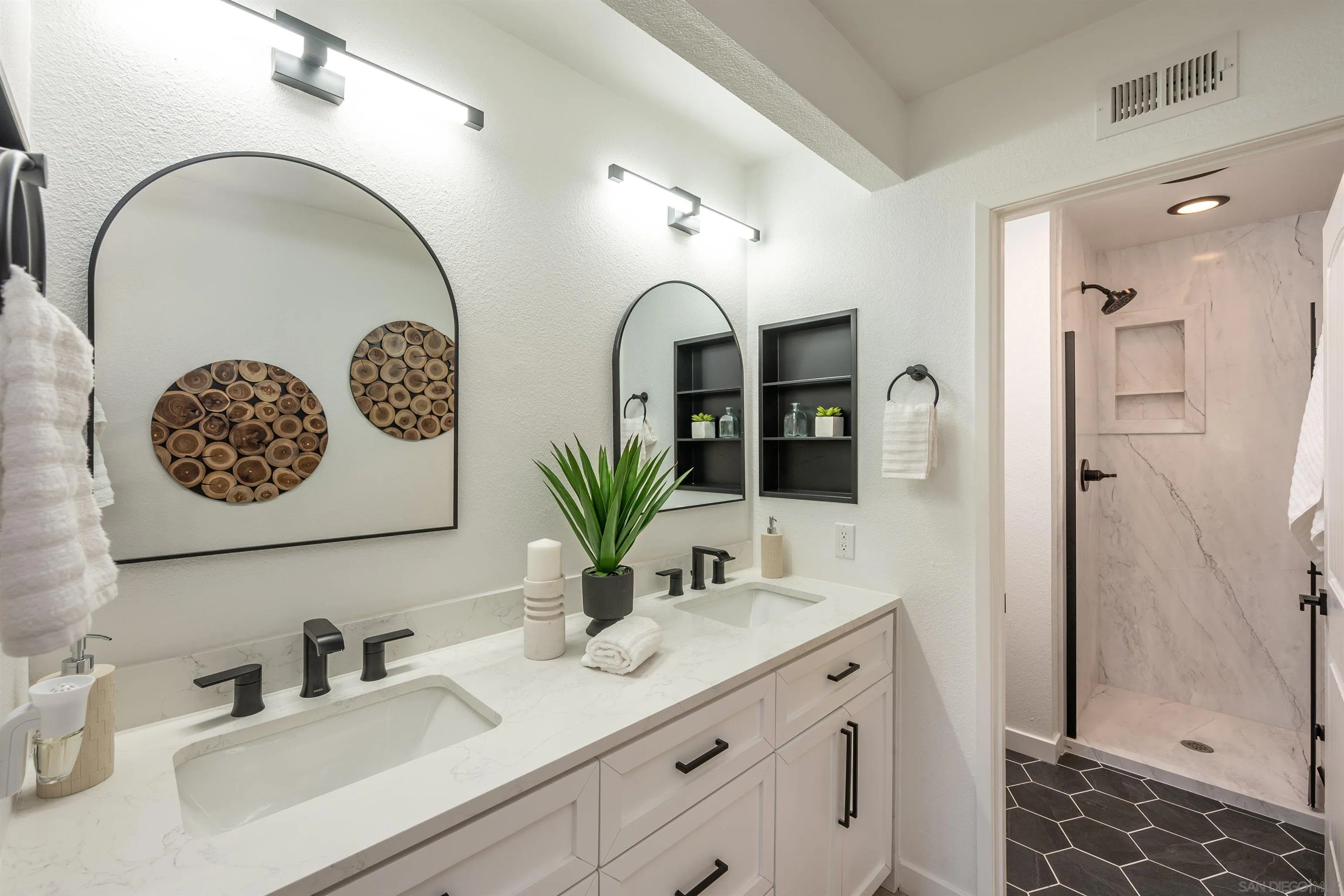 3577 Guava Way Oceanside, CA 92058 - Photo 30 of 42 a bathroom with a sink and a mirror