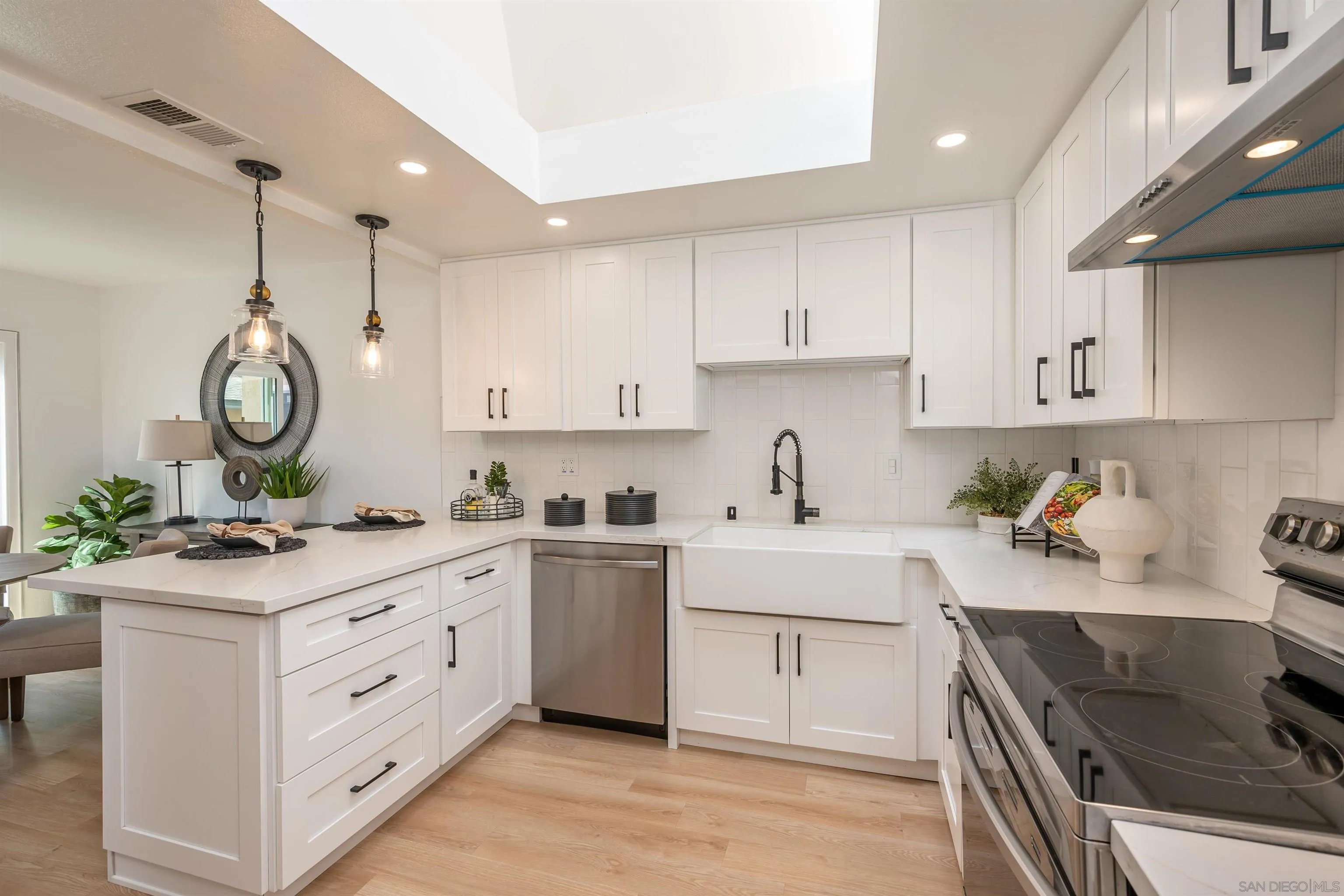 3577 Guava Way Oceanside, CA 92058 - Photo 9 of 42 a kitchen that has a lot of cabinets in it and stainless steel appliances