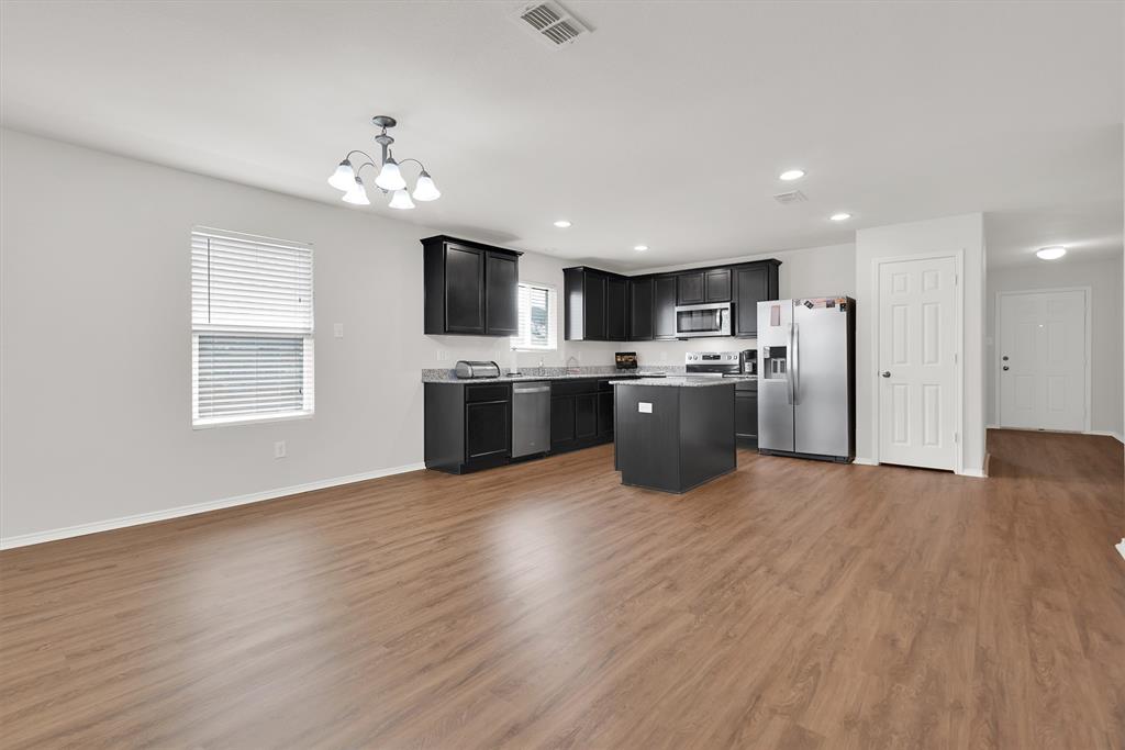 3011 Hickory Ridge Melissa, TX 75454 - Photo 10 of 30 Open-concept living space with wood-finish flooring, a contemporary chandelier, and recessed lighting