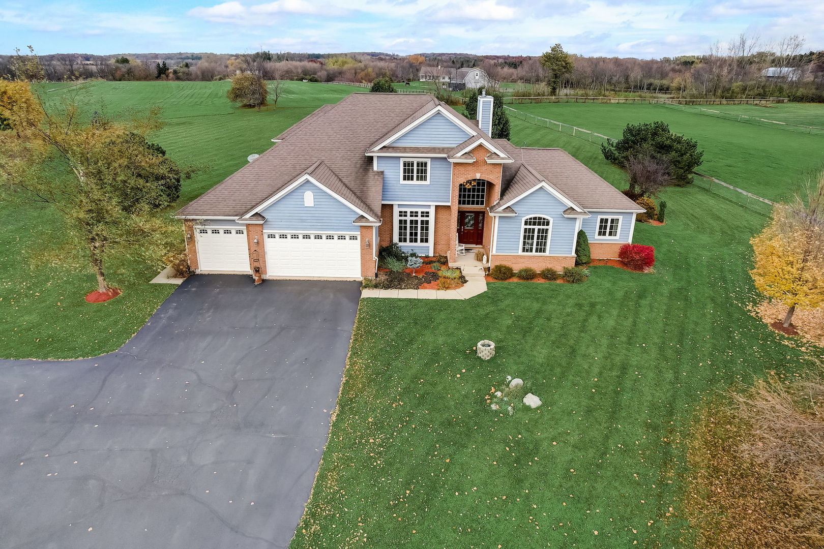 an aerial view of a house with garden space and lake view