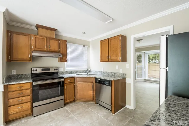 a kitchen with stainless steel appliances granite countertop a stove and a sink