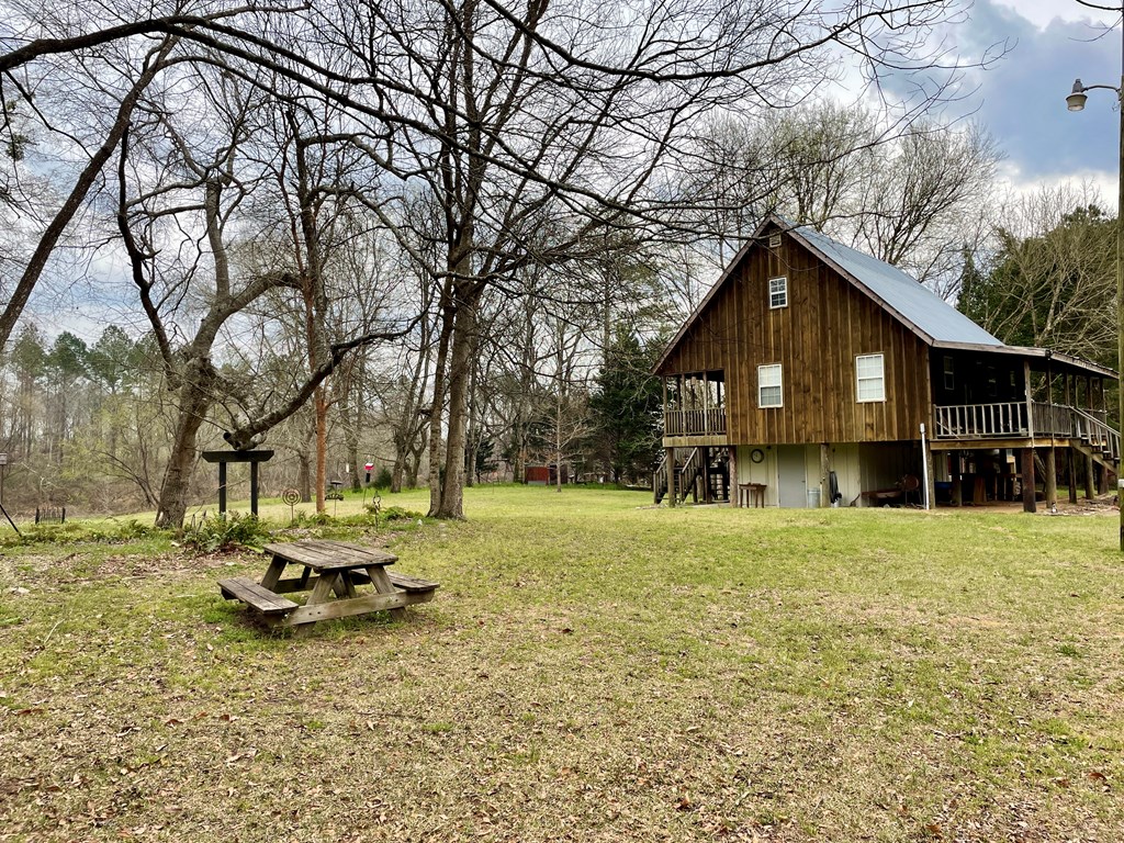 31 River Road Reynolds, GA 31076 - Photo 6 of 22 a front view of a house with a yard