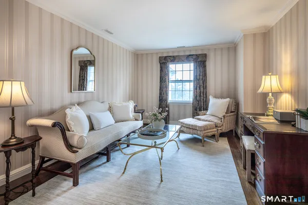 a living room with furniture wooden floor and a window