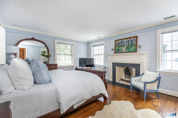 a spacious bedroom with a bed and a fireplace