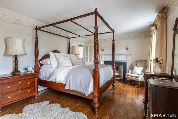 a bedroom with a bed window and a mirror