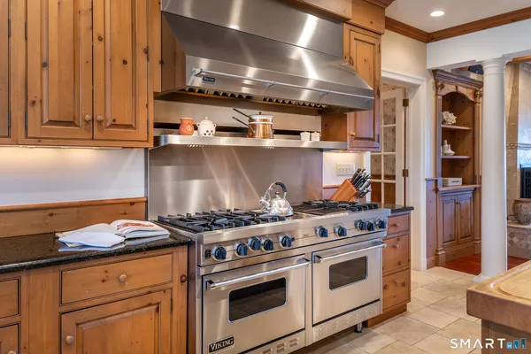 a kitchen with stainless steel appliances granite countertop a stove and a microwave