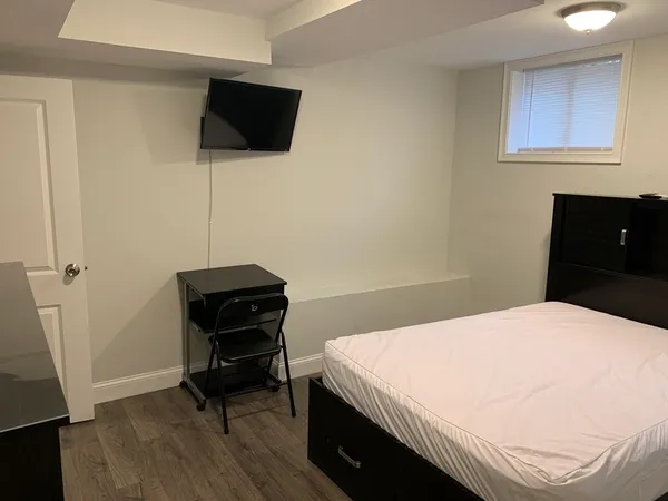 a bedroom with a bed and a television