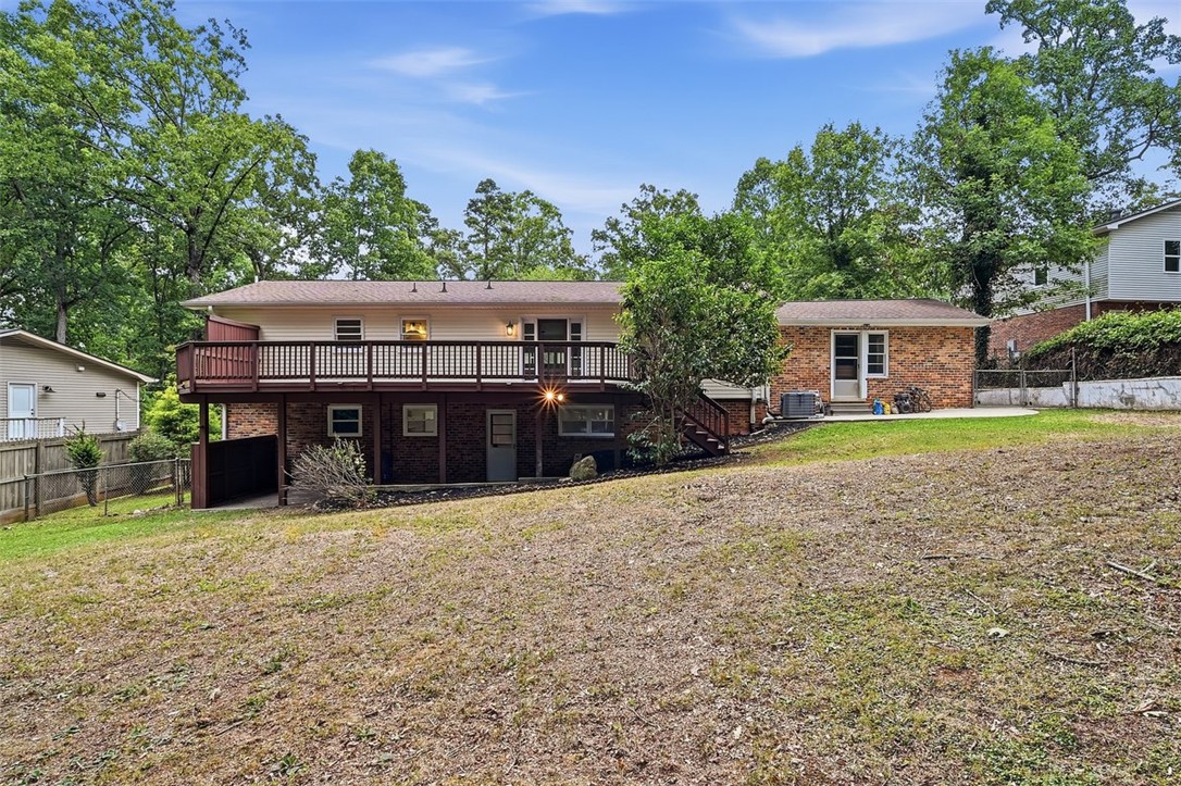 107 Edwards Mill Road Taylors, SC 29687 - Photo 27 of 34 A spacious backyard with an elevated deck offers ample outdoor living space.