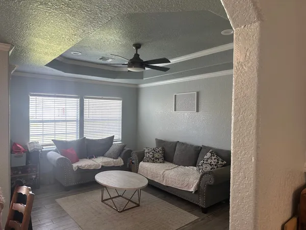 a living room with furniture and a large window