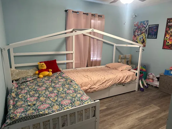 a bedroom with a bed and window