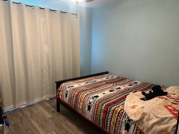 a bedroom with a bed and curtain