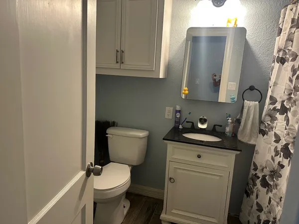 a white toilet sitting next to a bathroom sink