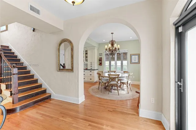a view of a dining room with furniture wooden floor and a chandelier