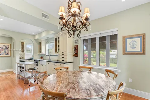 a view of a dining room with furniture wooden floor and chandelier